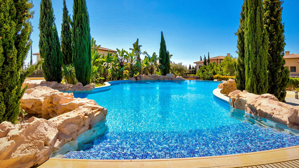 View of Alexander Heights Village communal pool on Aphrodite Hills Resort, Cyprus, with sea views.