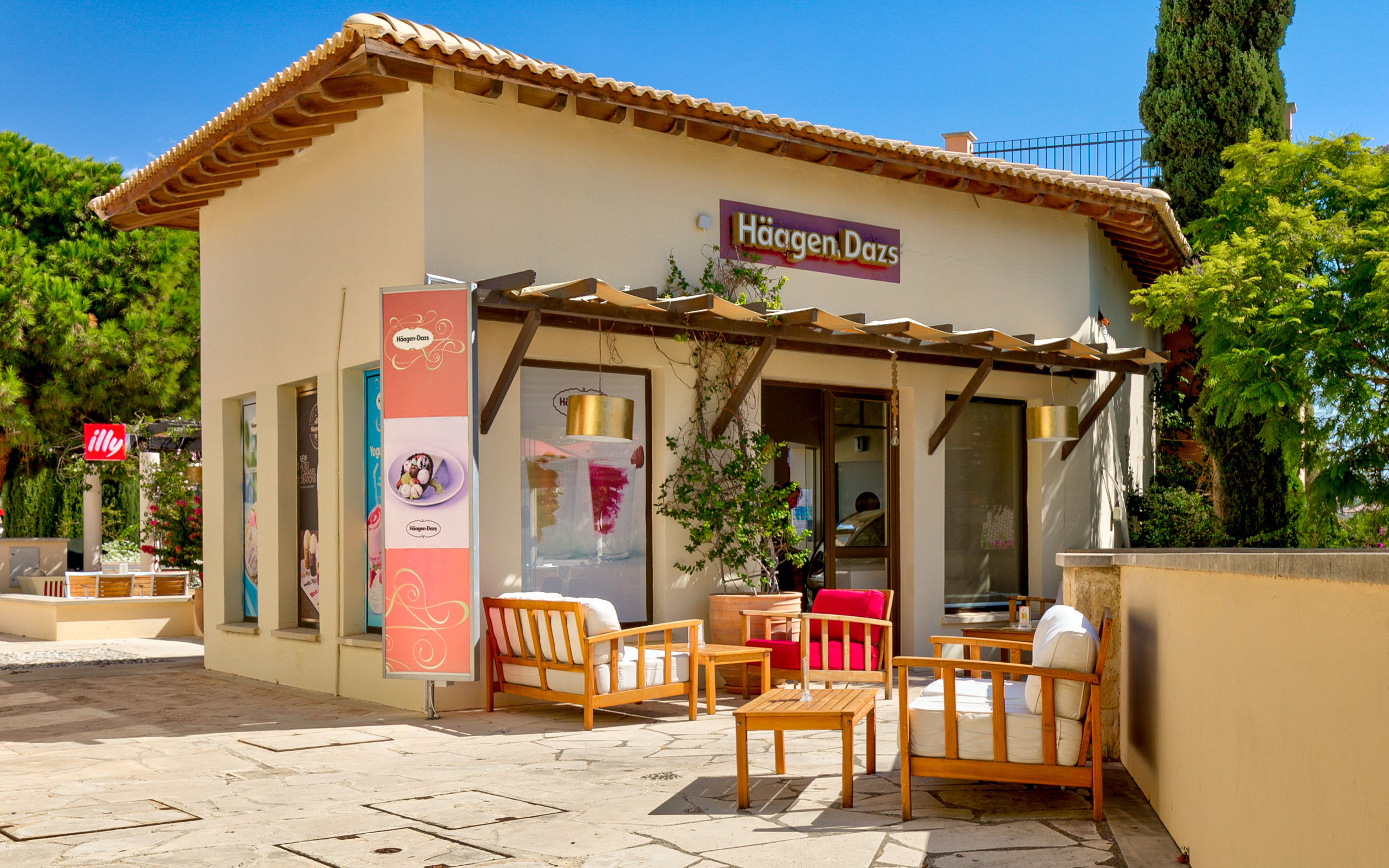 View of the Haagen Dazs cafe at Aphrodite Hills Resort, with comfortable seating outside. Cyprus.