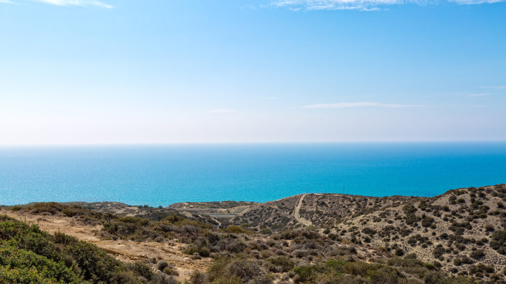 View of the Mediterranean sea from rugged hills on Aphrodite Hills Resort, Cyprus.