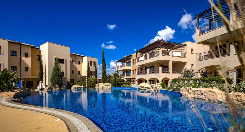View of apartment block from the communal pool at Alexander Heights at Aphrodite Hills Resort, Cyprus.