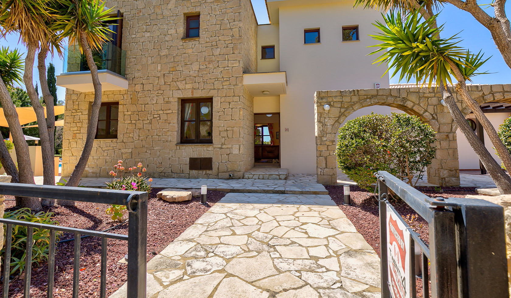 Image of Villa Kellia on Aphrodite Hills Resort, looking through gate at property entrance. Aphrodite Hills Resort, Cyprus.
