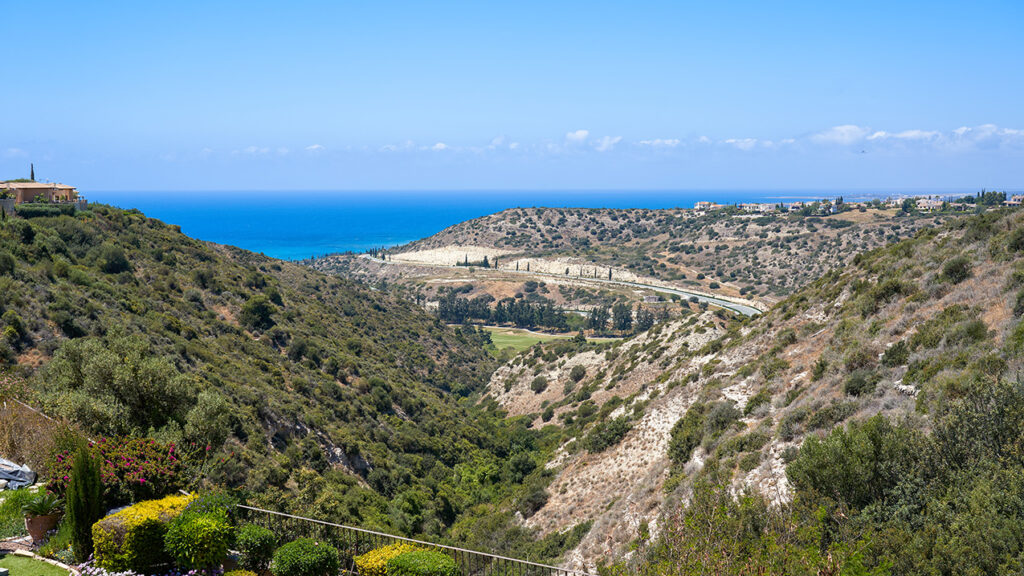 view of Mediterranean sea through a rugged valley overlooking Secret Valley golf course. Aphrodite Hills Resort, Cyprus.