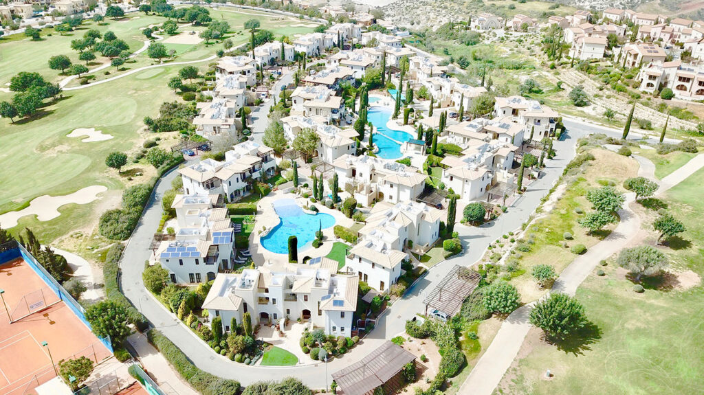 View of Helios Heights Village communal pool on Aphrodite Hills Resort, Cyprus, with sea views.