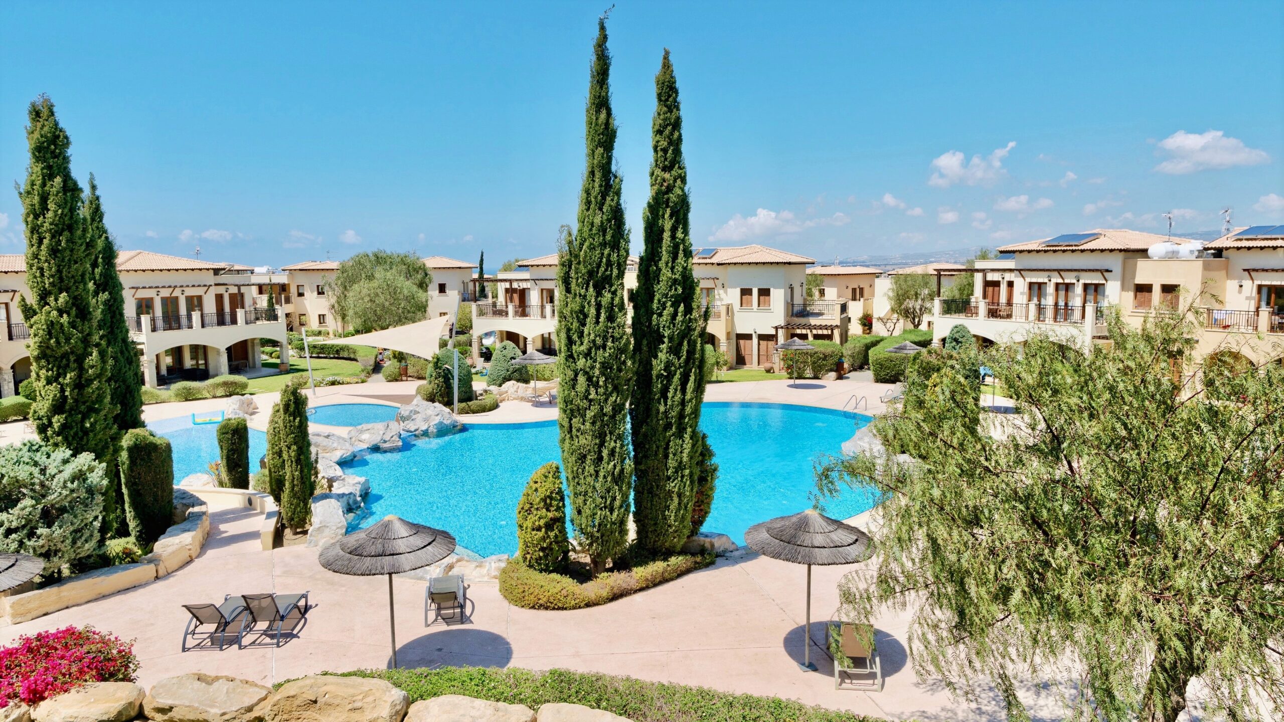Aerial view of Theseus village and communal pools, and surrounding apartment blocks. Aphrodite Hills Resort, Cyprus.