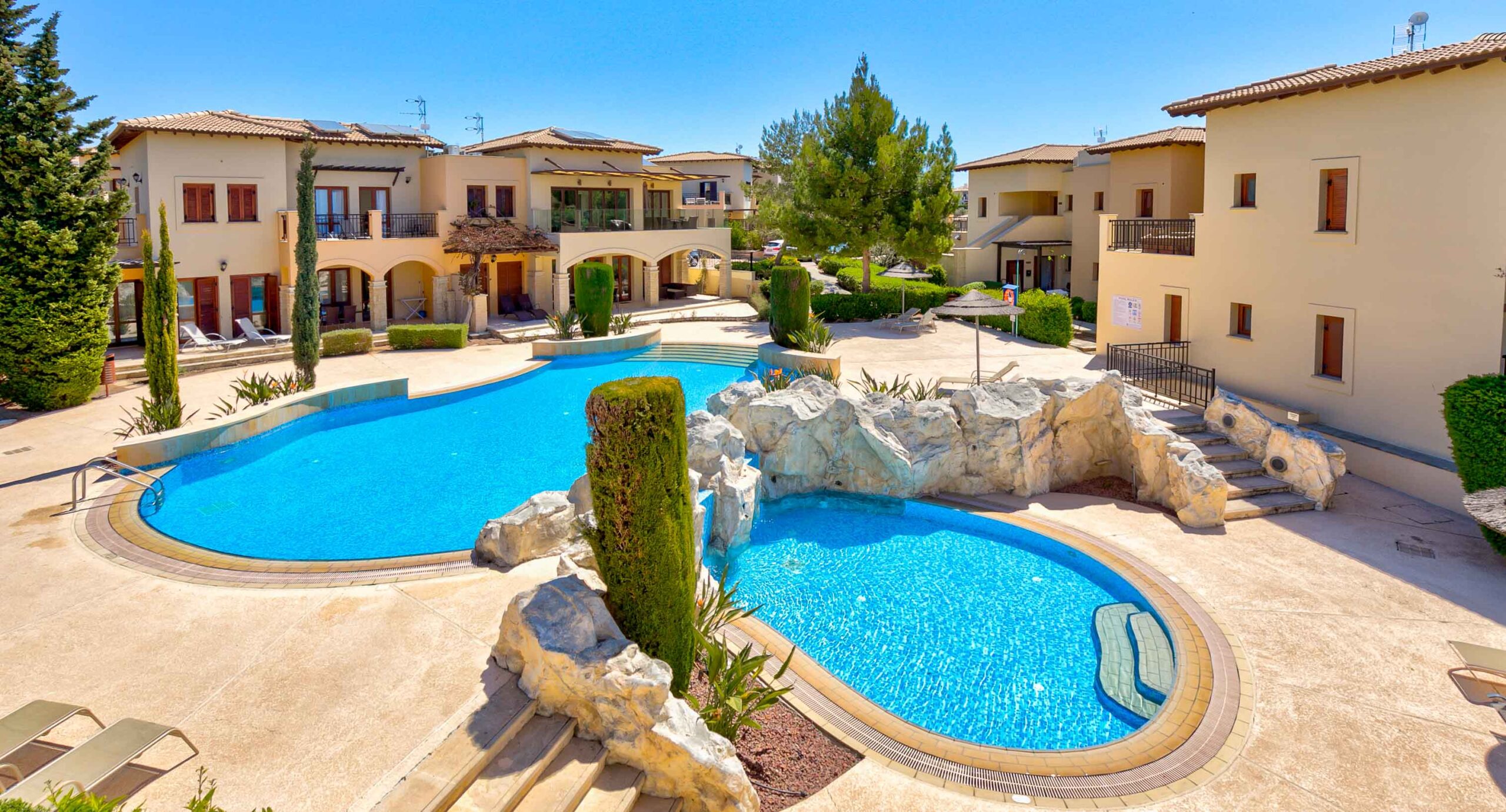 Aerial view of the smaller of the two communal pools on Theseus Village, Aphrodite Hills Resort, Cyprus.