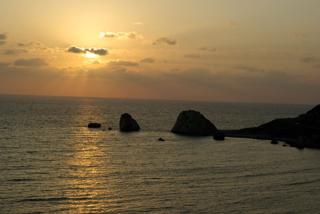 Sunset over the Mediterranean Sea, looking over Aphrodite's Rock formation on the coast of Paphos.