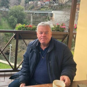 Photo of Martin Cook, Director at Comark Estates, with cup of coffee on an outdoor balcony in Cyprus.