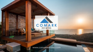 Advert for Comark Estates with logo and website address
