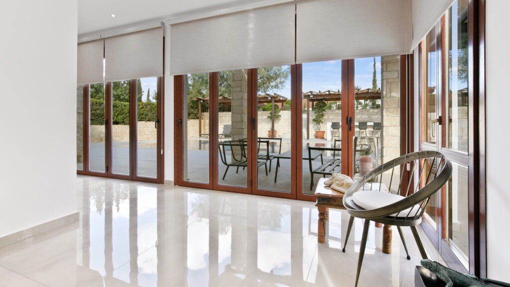 Living area bi-fold doors facing the outside terrace of Villa Agapi on Aphrodite Hills.
