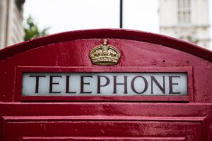 Top of a red phone box with word 'Telephone' showing.