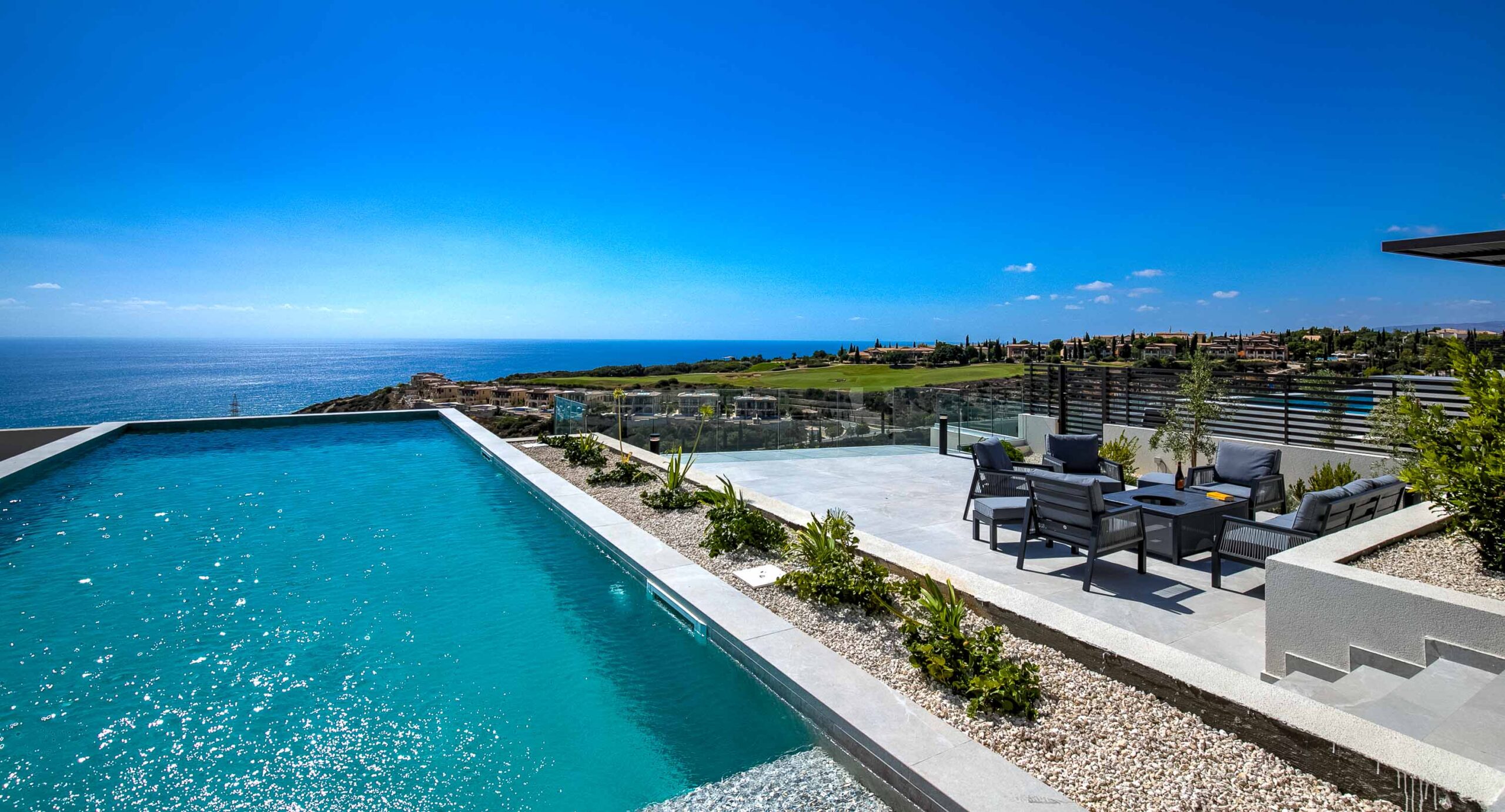 Photo of Villa 286 on Aphrodite Hills - showing the pool leading out to sea views, with seating area
