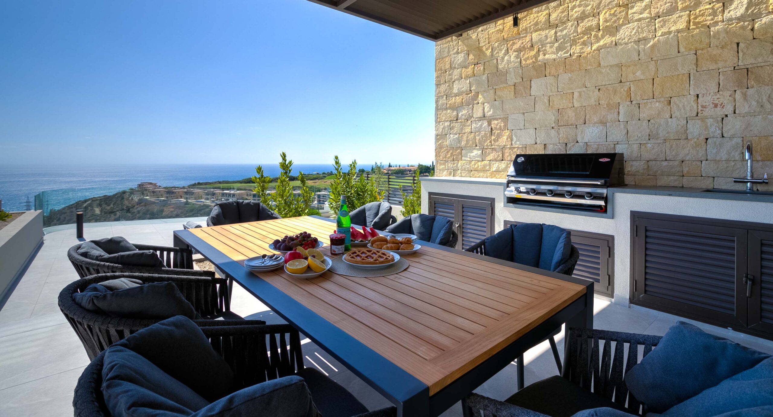 Photo of Villa 286 on Aphrodite Hills - outside terrace dining table (with breakfast set up), BBQ area and view to sea beyond.
