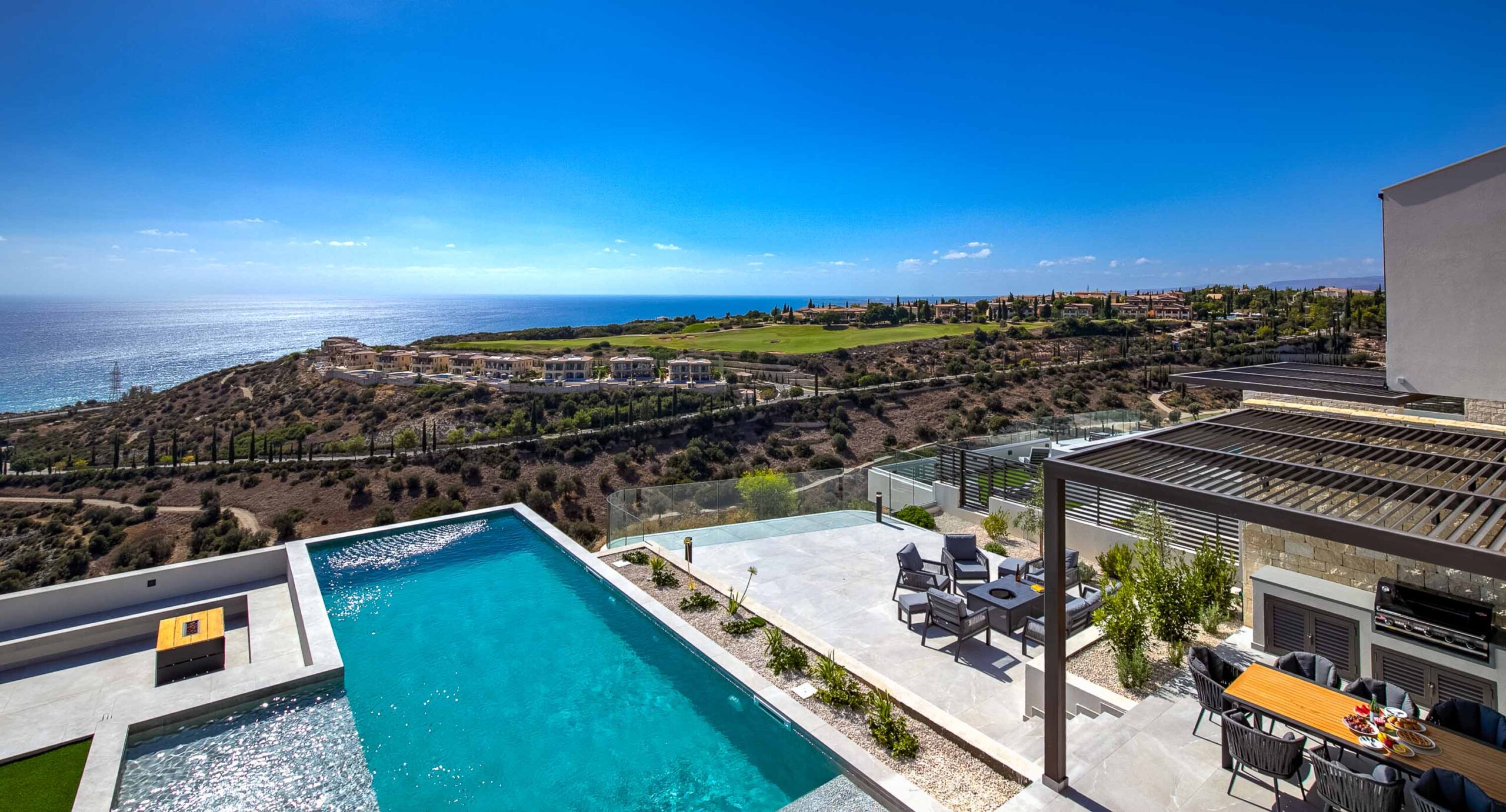 Photo of Villa 286 on Aphrodite Hills - View from upper balcony overlooking terrace and pool out to the golf course and sea beyond.