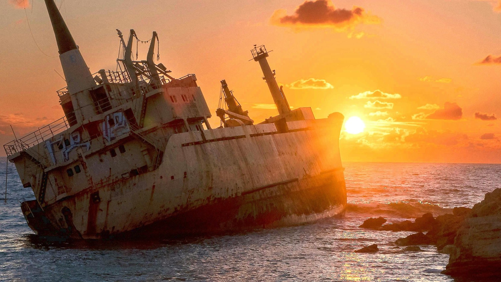 Photograph of sunset behind a shipwreck in Paphos, Cyprus